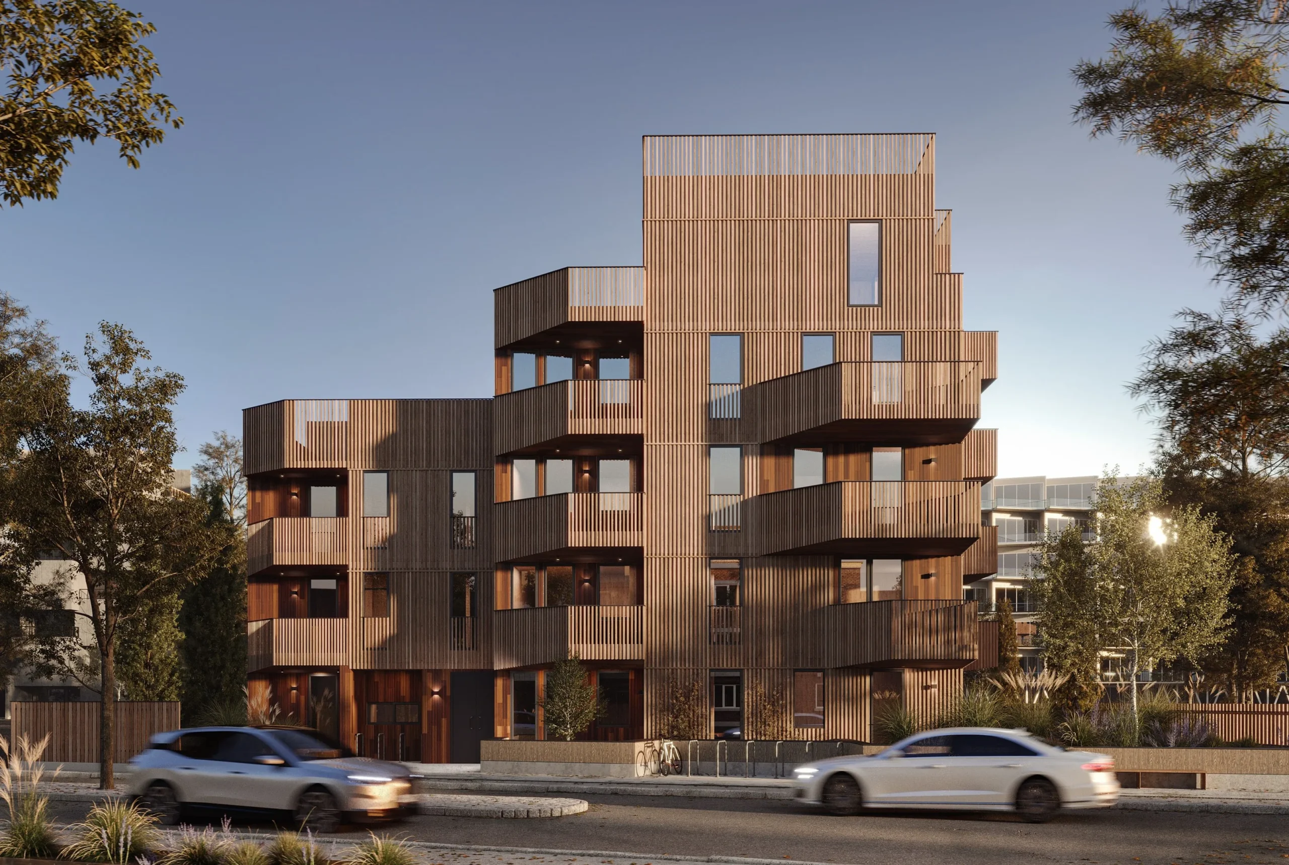 Modernus daugiabutis pastatas apšviestas vakarine saule sutvarkytoje kaiminystėje - NT Vizualizacijos